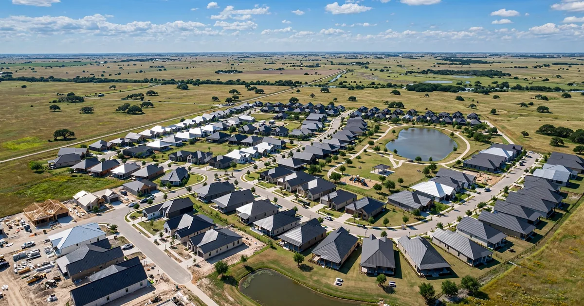 Metal roofing in Dixie Hollow, Pearland: aerial view of a subdivision with new standing-seam metal roofs