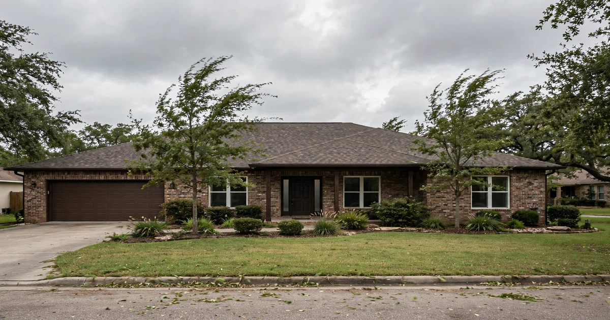 Westland Ranch roof repair in League City: ranch-style brick home with architectural shingles showing granule wear, breezy overcast sky